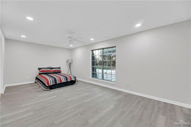 bedroom with ceiling fan and light hardwood / wood-style flooring