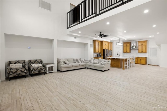 11115 N La Homa Rd, Mission, TX 78574 - living room with light wood-type flooring, ceiling fan, recessed lighting, and a high ceiling