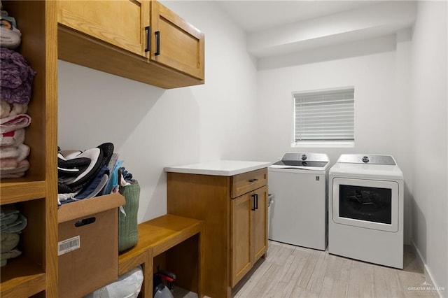 11115 N La Homa Rd, Mission, TX 78574 - laundry room with washer and clothes dryer, cabinet space, and light wood finished floors