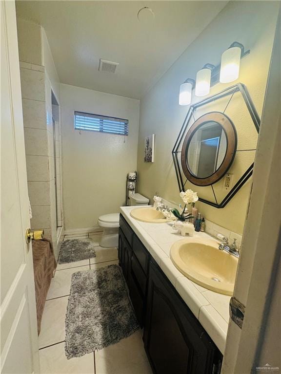 bathroom featuring double vanity, tile patterned flooring, a sink, and visible vents