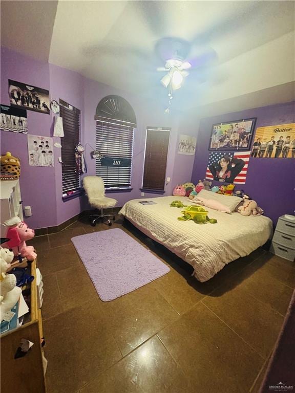 tiled bedroom featuring ceiling fan