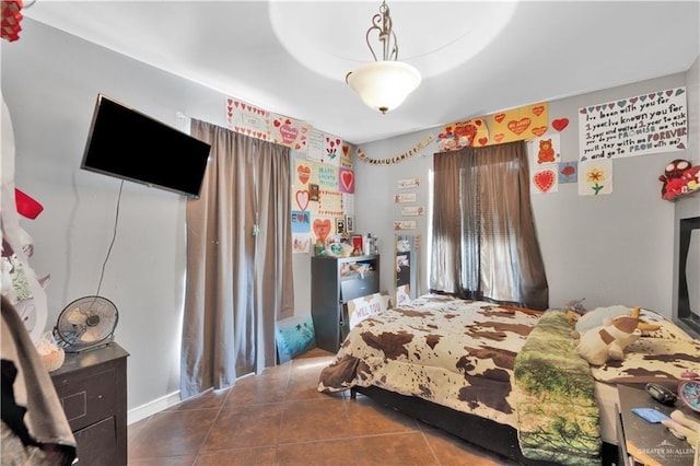 bedroom with dark tile patterned flooring