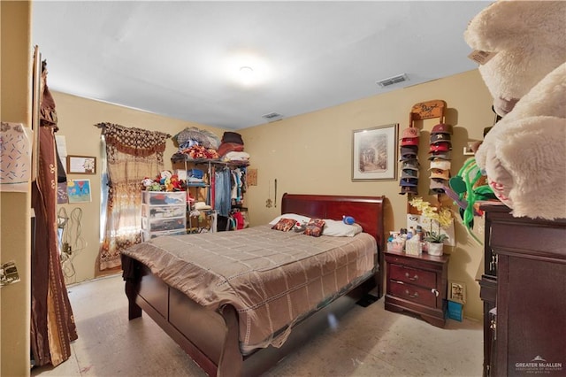 bedroom with concrete flooring and visible vents