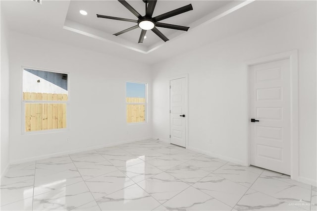 1922 Lime St, San Juan, TX 78589 - empty room with a tray ceiling, baseboards, a ceiling fan, light marble finish flooring, and recessed lighting