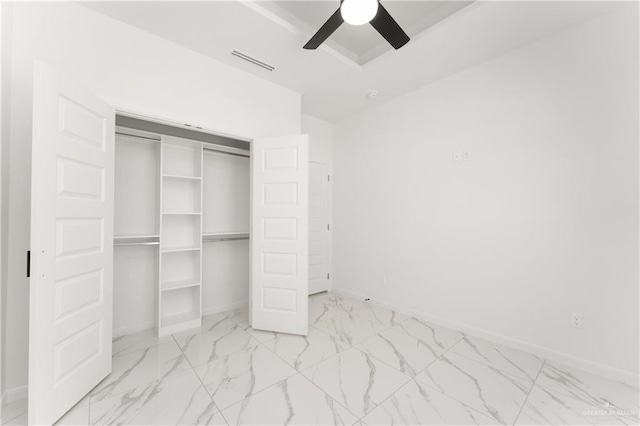 1922 Lime St, San Juan, TX 78589 - unfurnished bedroom with baseboards, a closet, light marble finish flooring, and a ceiling fan