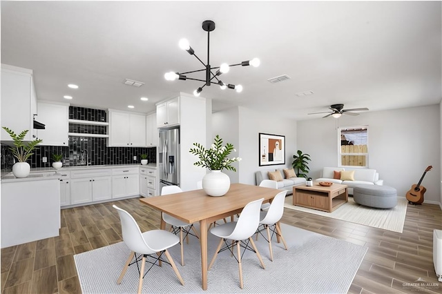 314 N Veterans Blvd, Edinburg, TX 78541 - dining room with wood finish floors, ceiling fan, a chandelier, recessed lighting, and baseboards