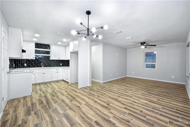 314 N Veterans Blvd, Edinburg, TX 78541 - kitchen with light wood-style flooring, decorative backsplash, white cabinetry, ceiling fan, and open floor plan