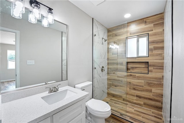314 N Veterans Blvd, Edinburg, TX 78541 - bathroom with toilet, a stall shower, wood finished floors, recessed lighting, and vanity