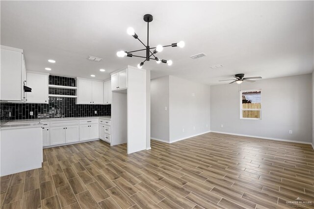 314 N Veterans Blvd, Edinburg, TX 78541 - kitchen with ceiling fan, baseboards, backsplash, light wood finished floors, and a chandelier