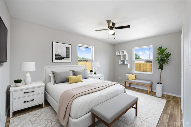 314 N Veterans Blvd, Edinburg, TX 78541 - bedroom featuring multiple windows, light wood-style floors, a ceiling fan, and baseboards