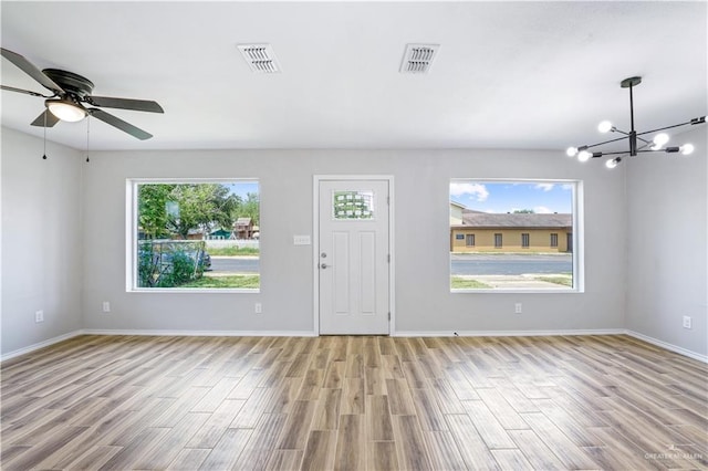 314 N Veterans Blvd, Edinburg, TX 78541 - foyer entrance featuring healthy amount of natural light, wood finished floors, and a chandelier