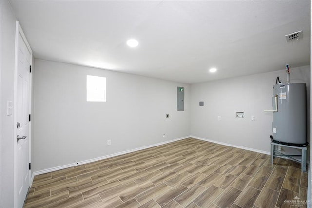 314 N Veterans Blvd, Edinburg, TX 78541 - basement featuring water heater, baseboards, wood finished floors, and recessed lighting