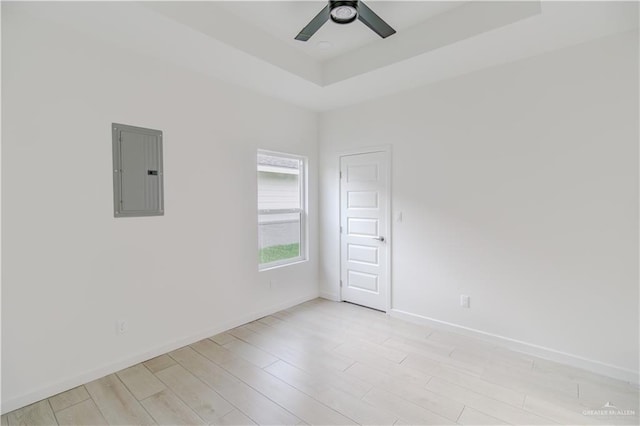 3414 Bamboo Palm Ct N, Harlingen, TX 78552 - unfurnished room with light wood-style flooring, electric panel, baseboards, a raised ceiling, and ceiling fan