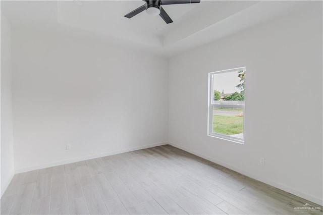 3414 Bamboo Palm Ct N, Harlingen, TX 78552 - spare room featuring a raised ceiling, baseboards, and light wood-style flooring