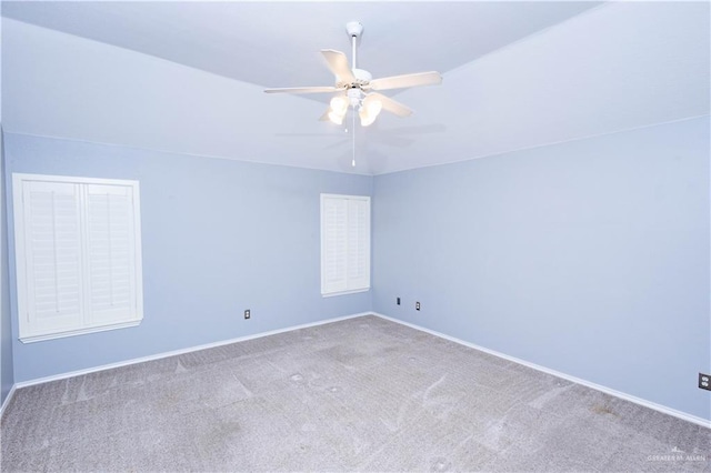 spare room with carpet flooring, a ceiling fan, and baseboards