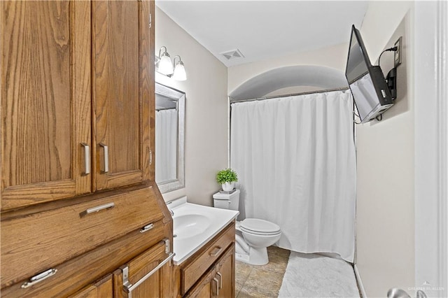 bathroom featuring toilet and vanity