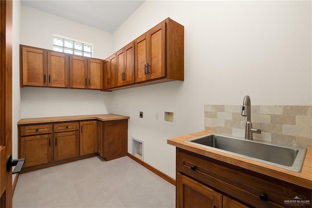 clothes washing area featuring cabinets, washer hookup, hookup for an electric dryer, sink, and light tile patterned flooring