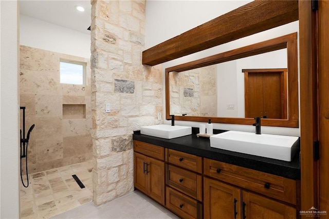 bathroom with vanity and tiled shower