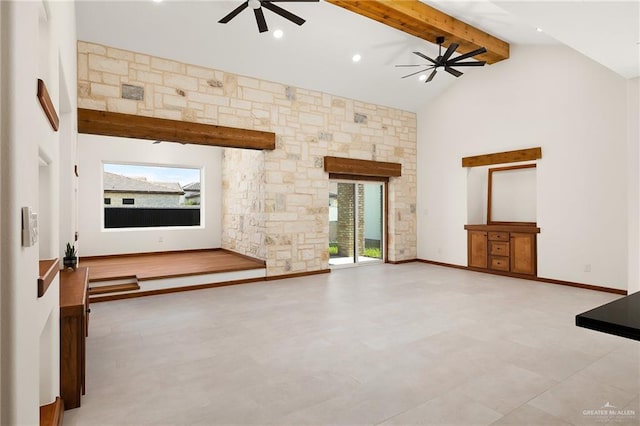 unfurnished living room with beamed ceiling, high vaulted ceiling, and ceiling fan