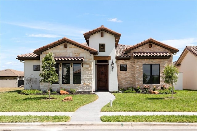 mediterranean / spanish-style house with a front lawn