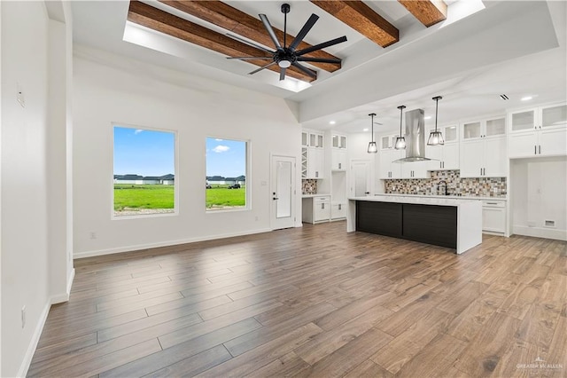 136 Finch Ln, Los Fresnos, TX 78566 - kitchen with island exhaust hood, ceiling fan, decorative backsplash, light countertops, and beamed ceiling