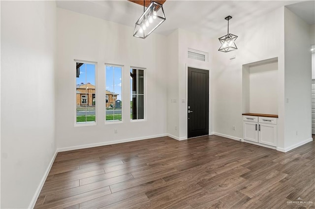 136 Finch Ln, Los Fresnos, TX 78566 - foyer with a high ceiling, dark wood-style flooring, and baseboards