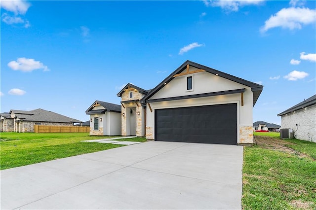136 Finch Ln, Los Fresnos, TX 78566 - view of front of house with stucco siding, driveway, a garage, stone siding, and central air condition unit