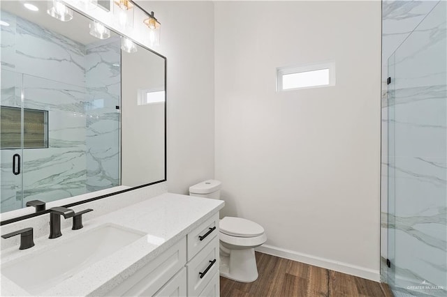 136 Finch Ln, Los Fresnos, TX 78566 - full bathroom with wood finished floors, vanity, toilet, baseboards, and a stall shower