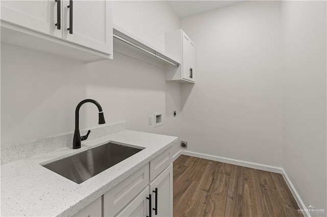 136 Finch Ln, Los Fresnos, TX 78566 - laundry area with hookup for an electric dryer, hookup for a washing machine, dark wood-type flooring, and baseboards