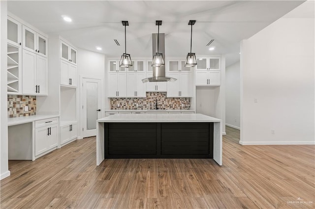 136 Finch Ln, Los Fresnos, TX 78566 - kitchen featuring tasteful backsplash, light countertops, light wood finished floors, and recessed lighting