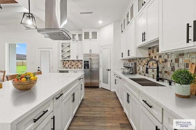 136 Finch Ln, Los Fresnos, TX 78566 - kitchen featuring stainless steel fridge, a sink, dark wood-style flooring, island exhaust hood, and white cabinets