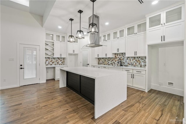 136 Finch Ln, Los Fresnos, TX 78566 - kitchen with tasteful backsplash, light countertops, a sink, white cabinets, and recessed lighting