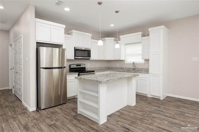 904 Kentucky St, Alton, TX 78573 - kitchen with appliances with stainless steel finishes, open shelves, a center island, dark wood-style floors, and recessed lighting