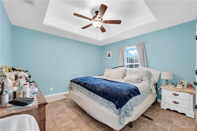 722 E Fay St, Edinburg, TX 78539 - bedroom featuring a raised ceiling, baseboards, and ceiling fan