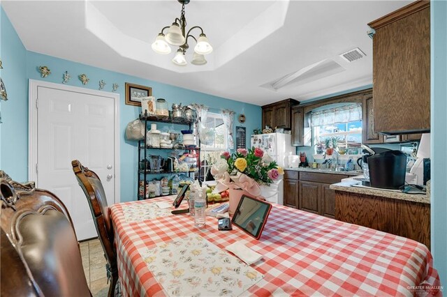 722 E Fay St, Edinburg, TX 78539 - dining room featuring a chandelier and a tray ceiling