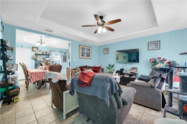 722 E Fay St, Edinburg, TX 78539 - living area featuring a tray ceiling, light tile patterned floors, a ceiling fan, and a chandelier