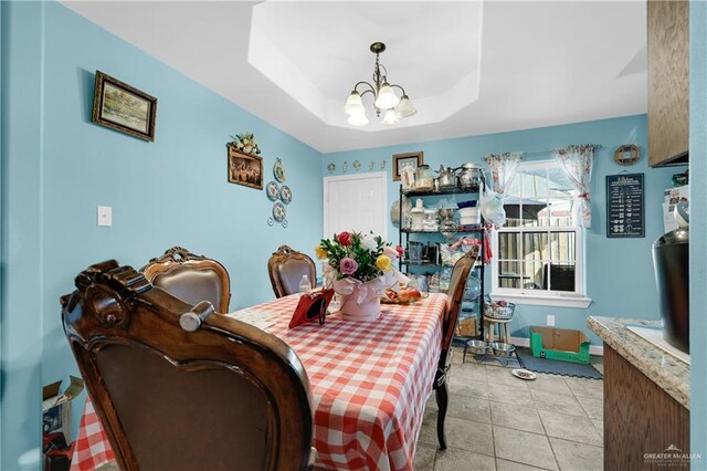 722 E Fay St, Edinburg, TX 78539 - dining space with a chandelier, light tile patterned floors, a tray ceiling, and baseboards