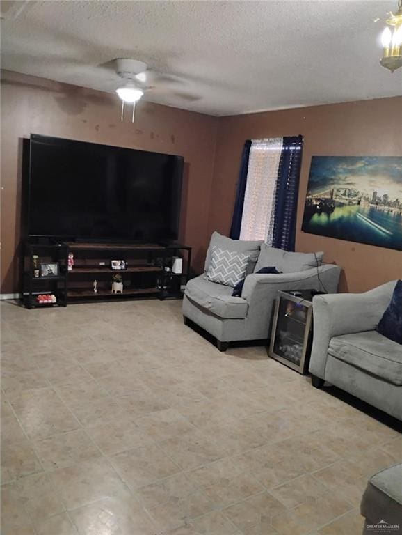 living room featuring a textured ceiling and ceiling fan