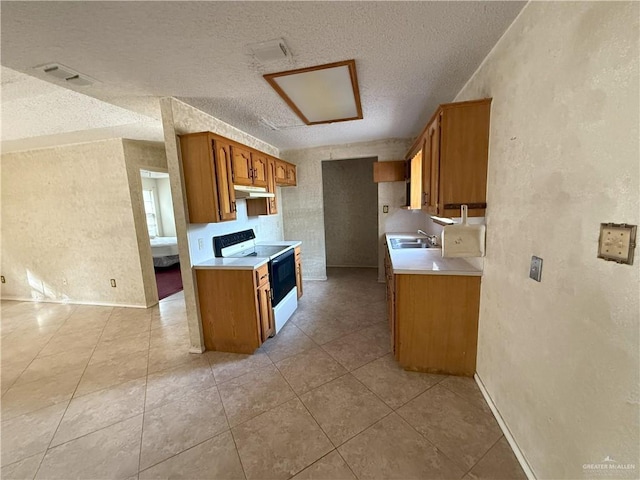 kitchen featuring white electric range oven, sink, and a textured ceiling