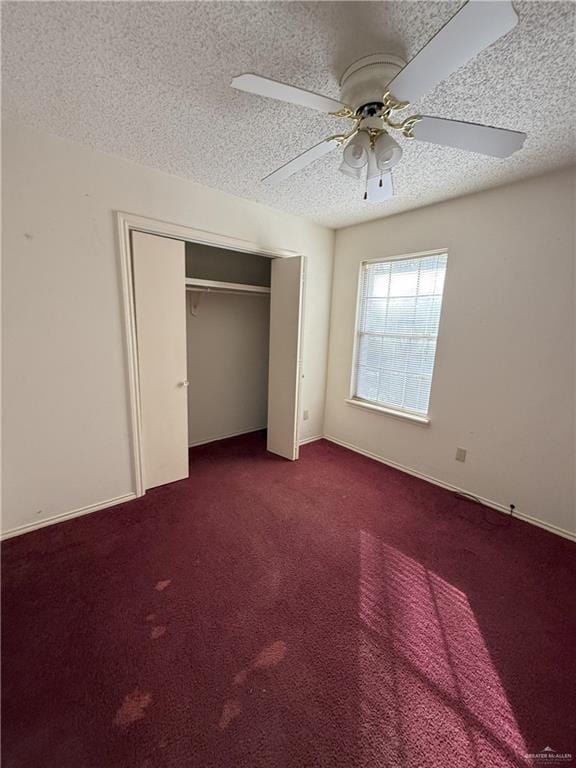 unfurnished bedroom with ceiling fan, a textured ceiling, a closet, and carpet