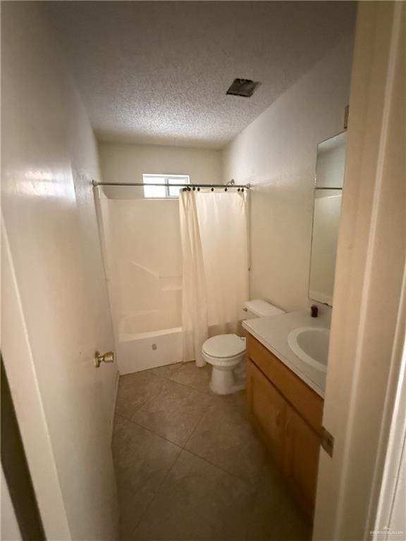 full bathroom featuring toilet, tile patterned flooring, shower / tub combo, a textured ceiling, and vanity