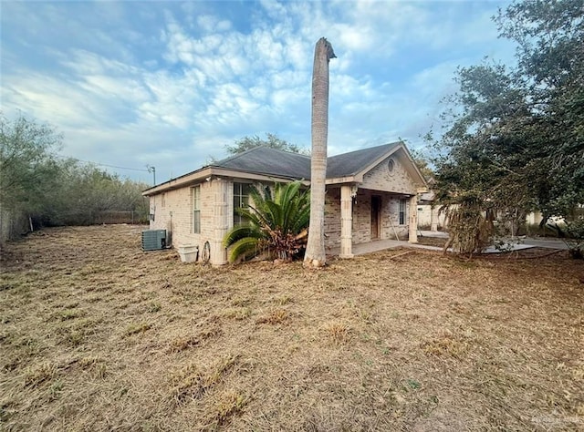 view of home's exterior featuring central AC and a lawn