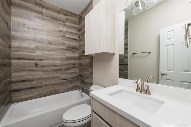 bathroom with tub / shower combination, vanity, and toilet