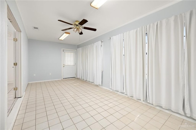 unfurnished room with light tile patterned floors, ceiling fan, and visible vents