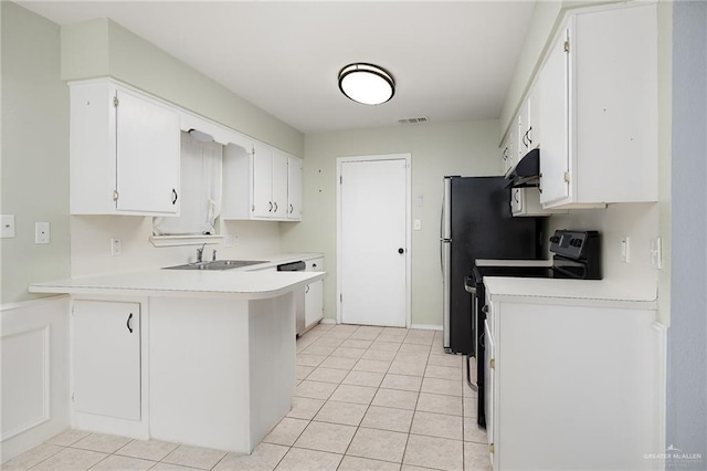 kitchen featuring white cabinets, light countertops, a sink, and visible vents