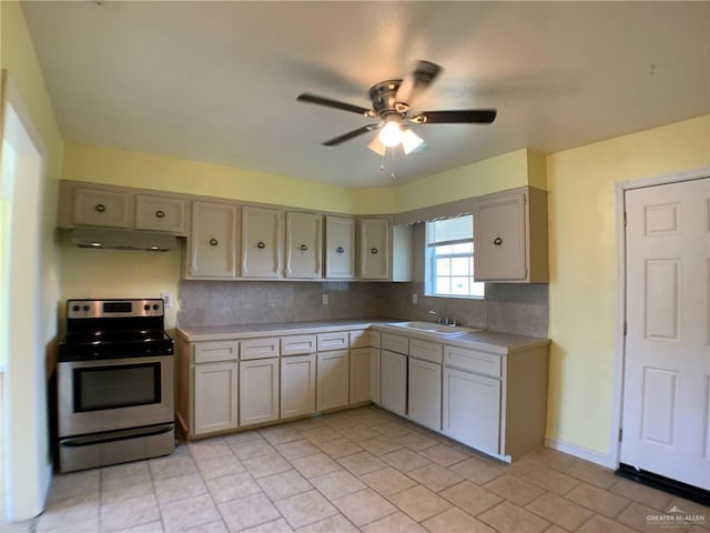 205 W Beck St, Harlingen, TX 78550 - kitchen with stainless steel electric range oven, light countertops, a ceiling fan, and under cabinet range hood