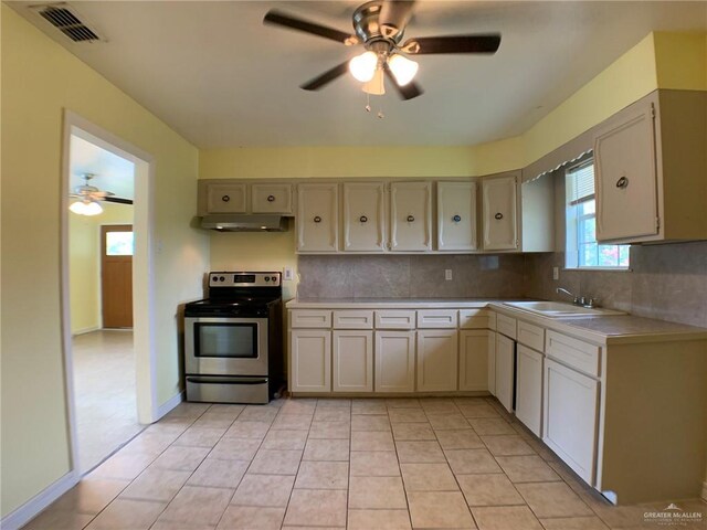 205 W Beck St, Harlingen, TX 78550 - kitchen with stainless steel electric range oven, a ceiling fan, light countertops, and tasteful backsplash