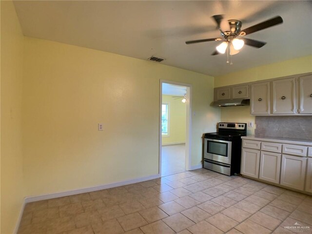 205 W Beck St, Harlingen, TX 78550 - kitchen featuring stainless steel electric range oven, under cabinet range hood, a ceiling fan, light countertops, and backsplash