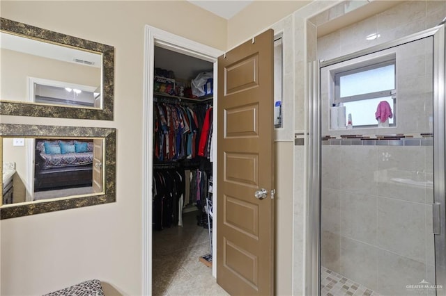 3008 Brush Dr, Weslaco, TX 78599 - full bath featuring a stall shower, a walk in closet, vanity, and tile patterned flooring