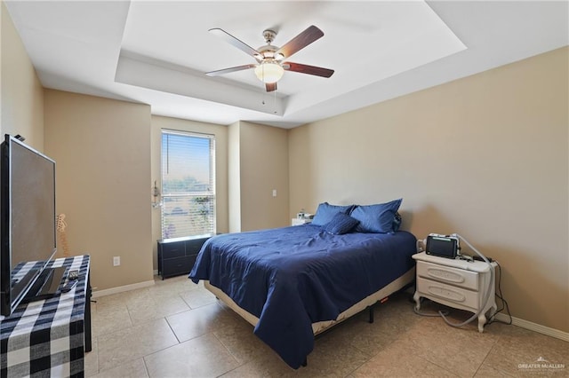 3008 Brush Dr, Weslaco, TX 78599 - bedroom featuring a tray ceiling, baseboards, a ceiling fan, and light tile patterned floors